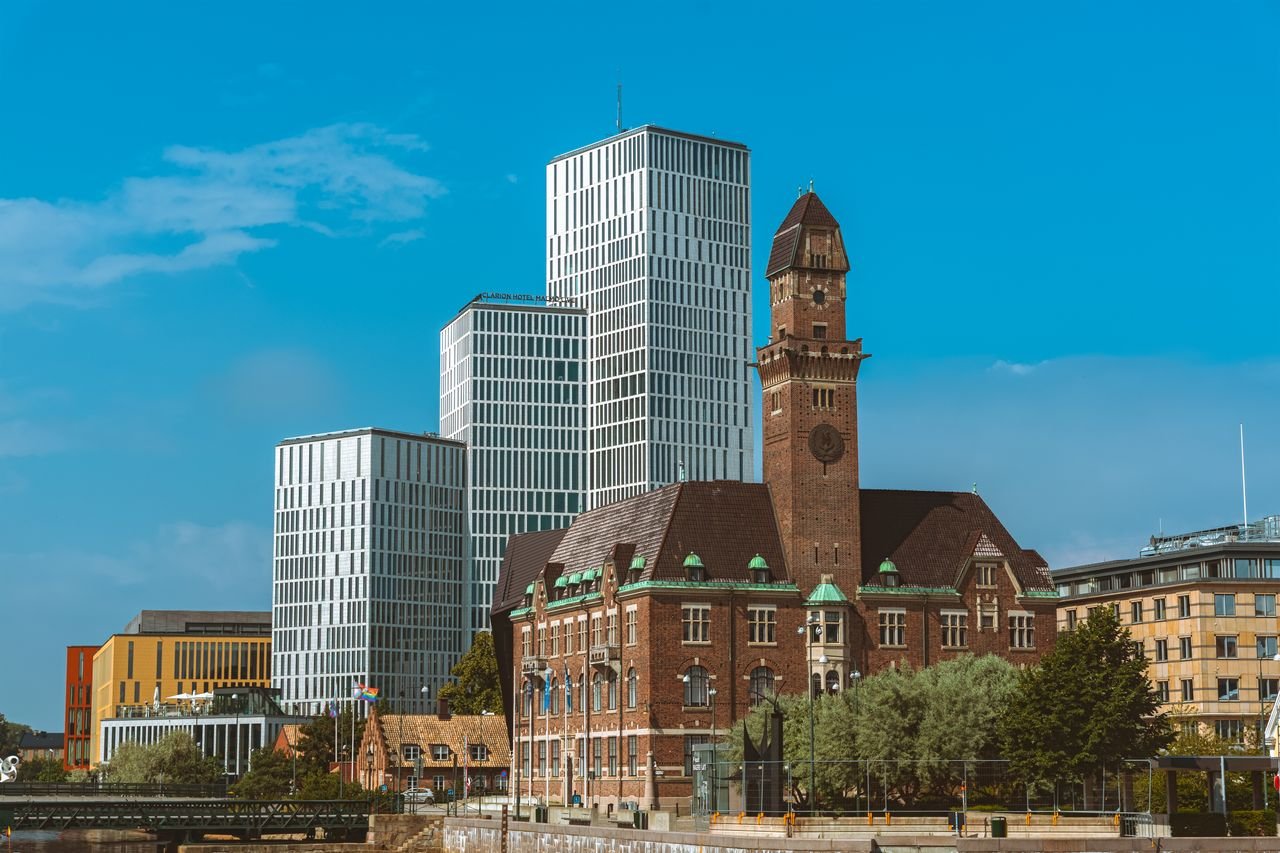 A striking contrast of modern skyscrapers and historic architecture in Malmö, Sweden.