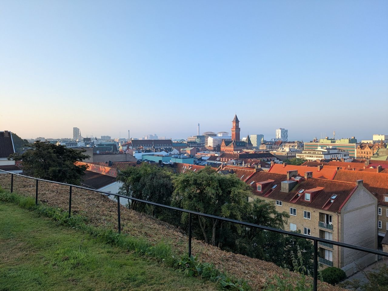 A beautiful view over Helsingborg cityscape with iconic buildings and red rooftops under a clear sky.